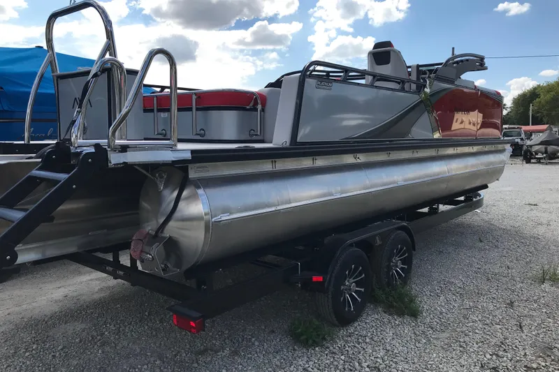 Slide: The Image of 2026 Avalon LSZ Entertainer boat interior with red and white seating, table, and cup holders. - 14