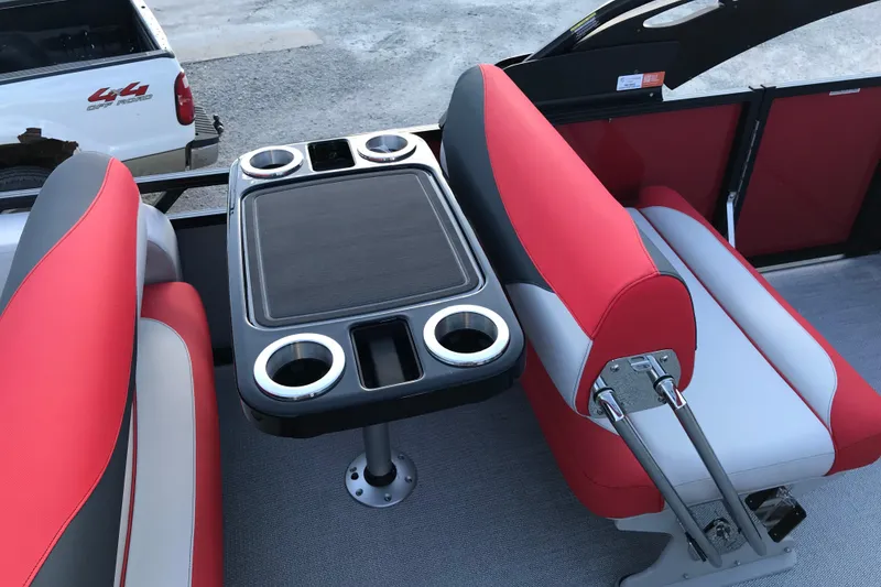 Slide: The Image of 2026 Avalon LSZ ENTERTAINER boat interior with red and gray seating, table, and cup holders. - 19