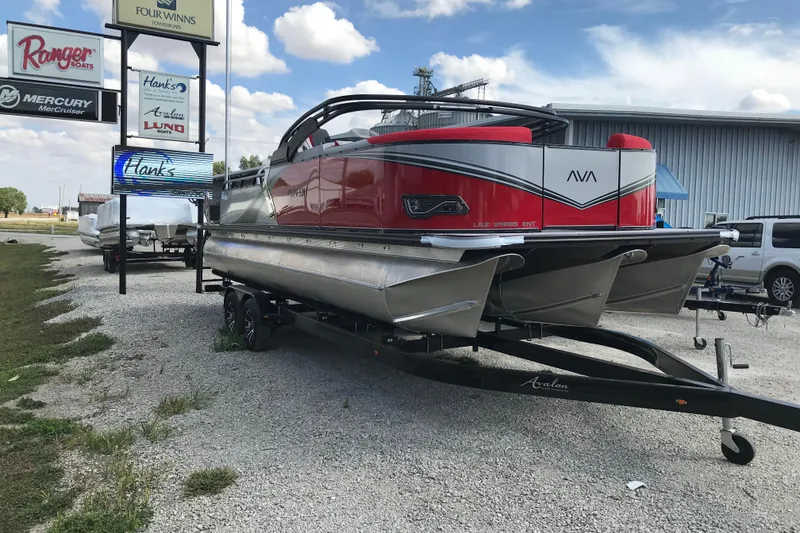 Slide: The Image of 2026 Avalon LSZ Entertainer pontoon boat on trailer, vibrant red and silver design. - 2