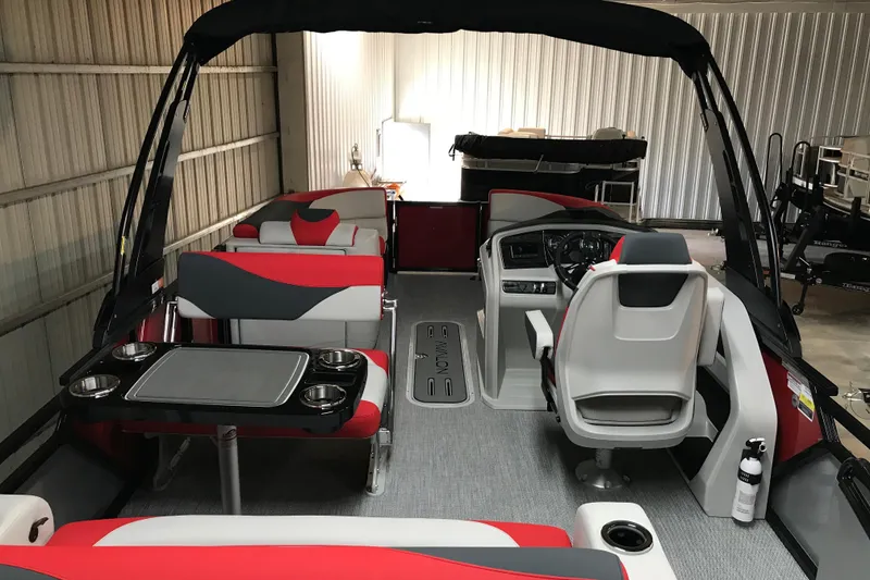 Slide: The Image of 2026 Avalon LSZ Entertainer pontoon boat with ladder, parked on gravel. - 4