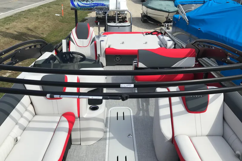 Slide: The Image of 2026 Avalon LSZ Entertainer boat interior with red and white seating, gray flooring. - 7