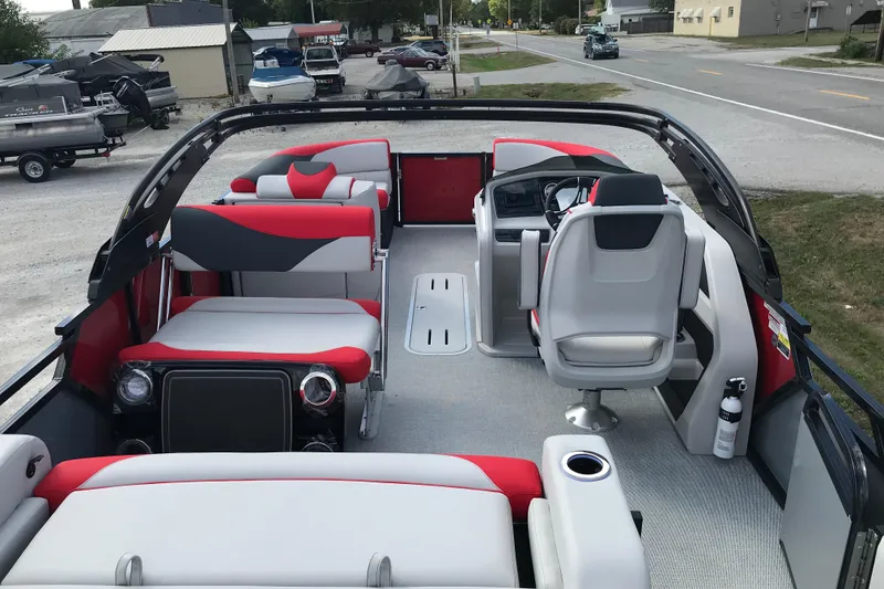 Slide: The Image of 2026 Avalon LSZ ENTERTAINER boat with sleek metal railing and storage compartment. - 9