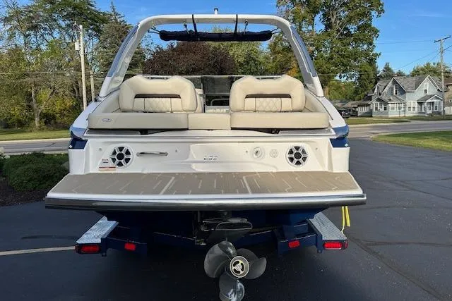 Slide: The Image of 2026 Regal LS6 boat rear view with seating and speakers on a trailer. - 2