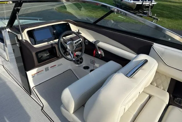 Slide: The Image of Interior of 2026 Regal LS6 boat with modern dashboard and steering wheel. - 7