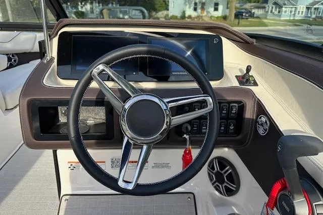 Slide: The Image of Steering wheel and dashboard of 2026 Regal LS6 boat, featuring modern controls and displays. - 8