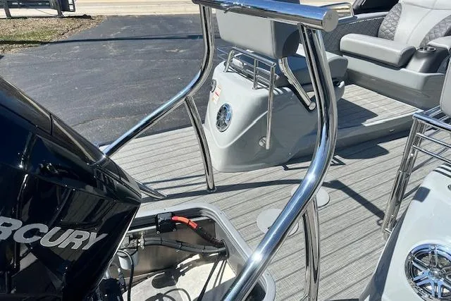 Slide: The Image of 2024 Manitou LX 25 SRS boat interior with Mercury engine and sleek seating. - 10