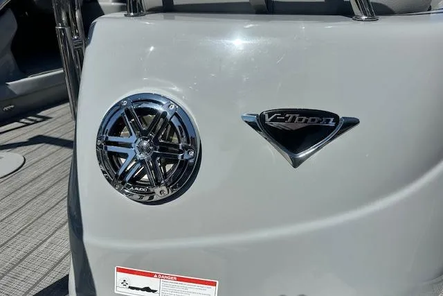 Slide: The Image of 2024 Manitou LX 25 SRS boat with speaker and V-Toon logo detail. - 12