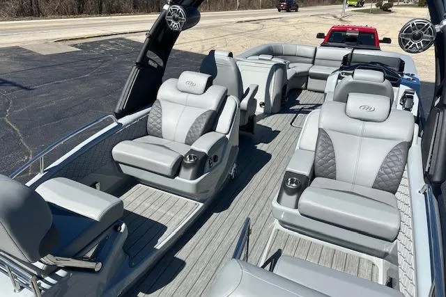 Slide: The Image of 2024 Manitou LX 25 SRS pontoon boat with luxurious seating and modern design. - 13