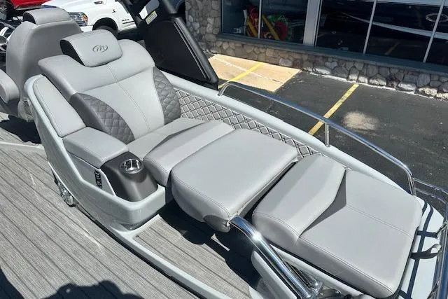 Slide: The Image of Luxurious seating on 2024 Manitou LX 25 SRS boat with gray upholstery and cup holder. - 14