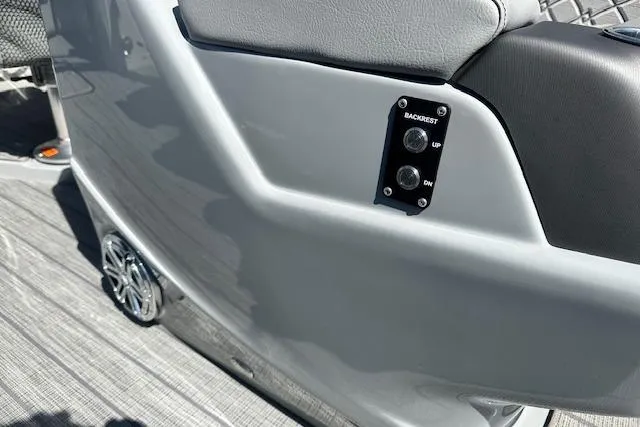 Slide: The Image of 2024 Manitou LX 25 SRS boat interior with backrest controls and speaker detail. - 17