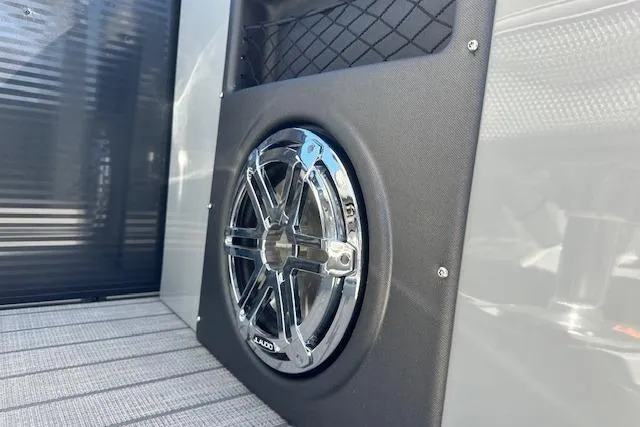 Slide: The Image of 2024 Manitou LX 25 SRS speaker detail with chrome finish and mesh storage. - 20