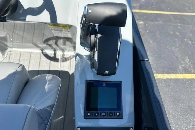 Slide: The Image of 2024 Manitou LX 25 SRS boat console with throttle and digital display. - 23