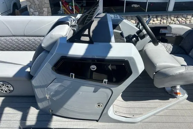 Slide: The Image of 2024 Manitou LX 25 SRS boat interior with modern helm and seating. - 27