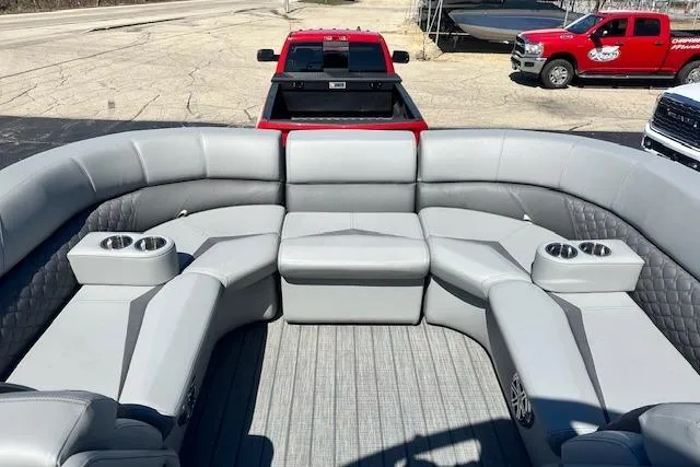 Slide: The Image of 2024 Manitou LX 25 SRS pontoon boat with spacious seating and cup holders. - 30