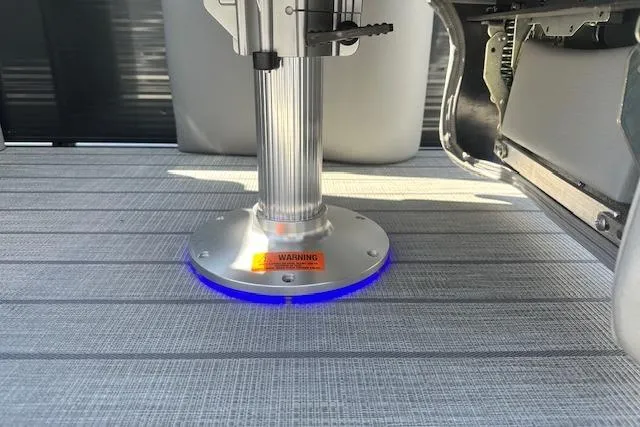 Slide: The Image of 2024 Manitou LX 25 SRS boat pedestal with blue LED lighting on deck. - 34