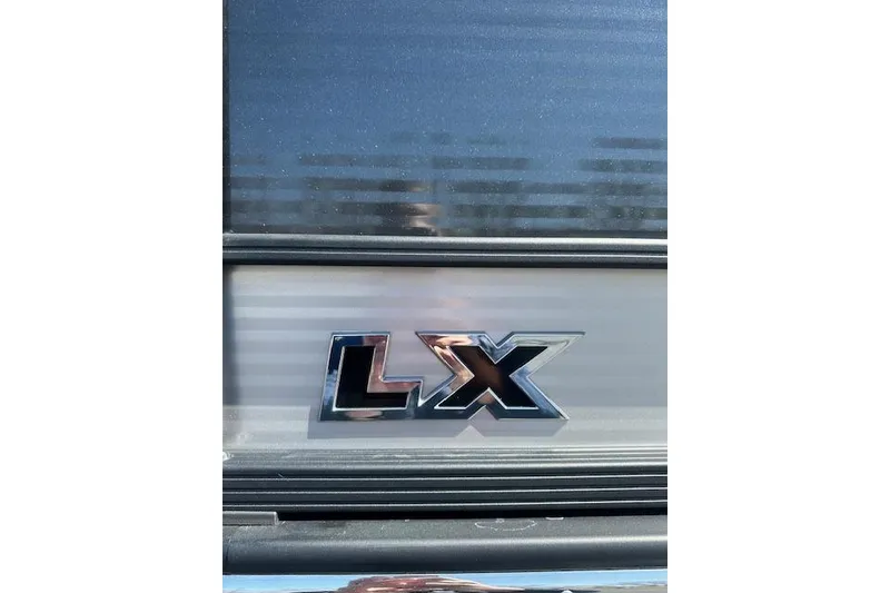 Slide: The Image of 2024 Manitou LX 25 SRS emblem on a sleek metallic surface. - 4