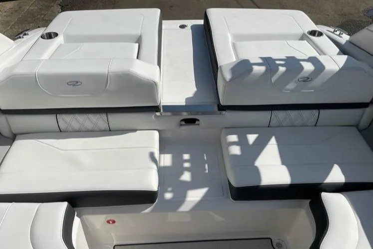 Slide: The Image of 2025 Regal LS2 Surf boat interior with white cushioned seating and cup holders. - 9