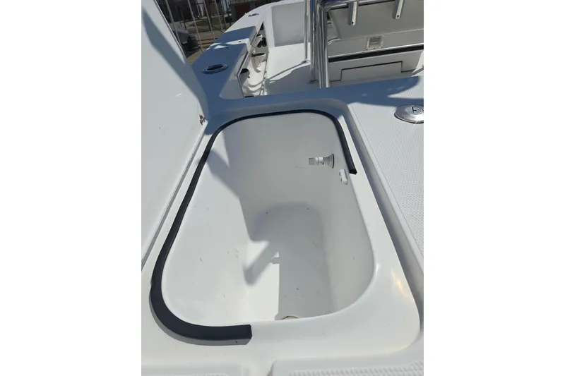 Slide: The Image of Open storage compartment on 2002 Rinalli 2100 boat deck, featuring clean white interior. - 15