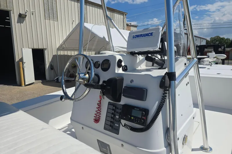 Slide: The Image of Center console of a 2002 Rinalli 2100 boat with steering wheel and navigation equipment. - 17