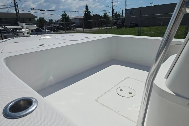 Slide: The Image of Open deck of a 2002 Rinalli 2100 boat under a sunny sky. - 18