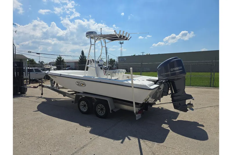 Slide: The Image of 2002 Rinalli 2100 boat on trailer with Yamaha outboard motor, parked outdoors. - 3