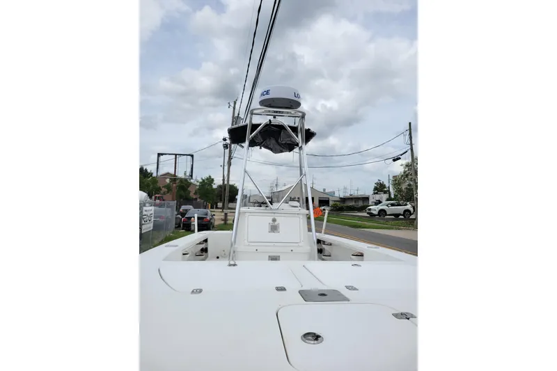 Slide: The Image of 2002 Rinalli 2100 boat with radar tower, parked on a street under cloudy skies. - 9