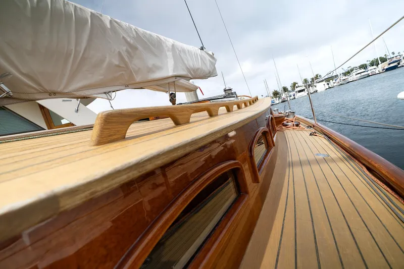 Slide: The Image of Luxurious 2011 Spirit 50 DH yacht with sleek wooden deck and marina view. - 10