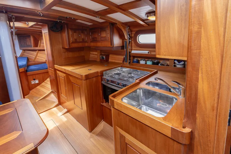 Slide: The Image of Luxurious wooden interior of 2011 Spirit 50 DH yacht kitchen with stove and sink. - 16