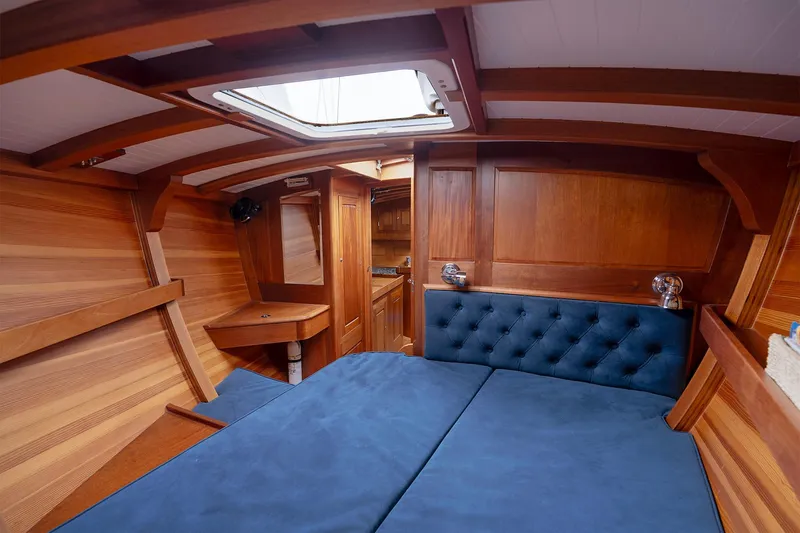 Slide: The Image of Luxurious wooden interior of 2011 Spirit 50 DH yacht with blue cushioned seating. - 19