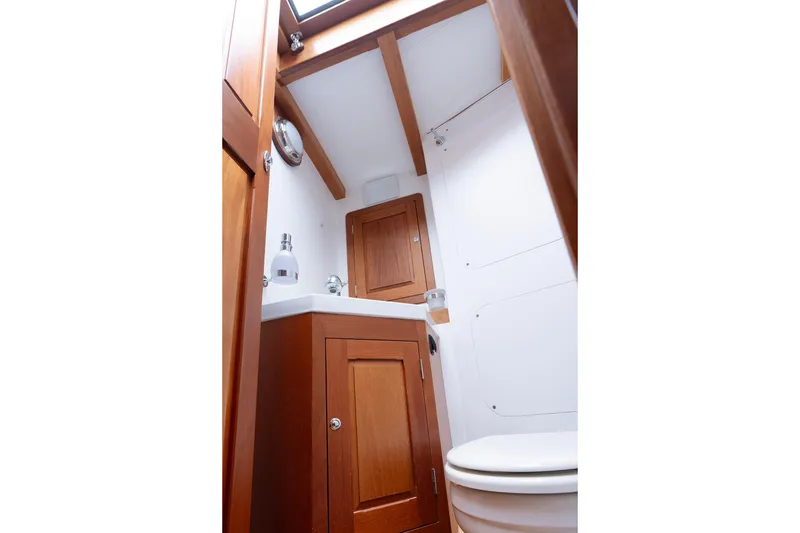 Slide: The Image of 2011 Spirit 50 DH yacht bathroom with wooden cabinetry and modern fixtures. - 22