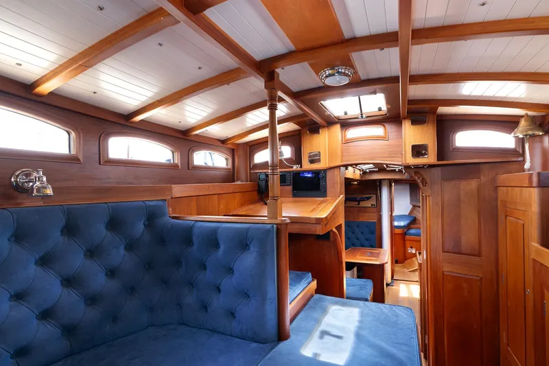 Slide: The Image of Luxurious 2011 Spirit 50 DH yacht interior with elegant wood finish and plush blue seating. - 28