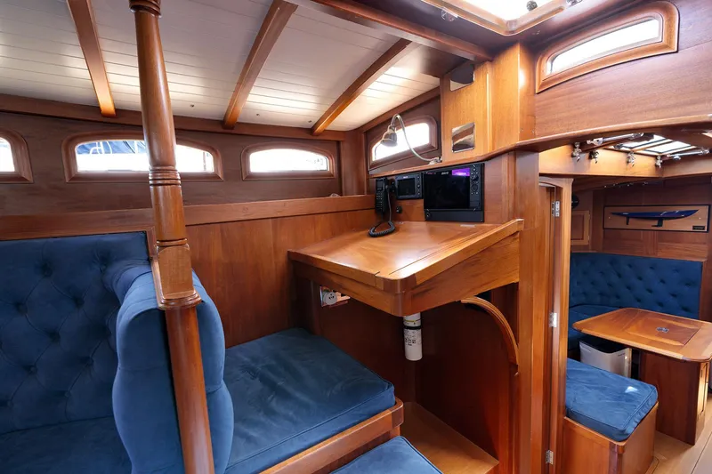Slide: The Image of Luxurious 2011 Spirit 50 DH yacht interior with elegant wood finish and plush blue seating. - 29