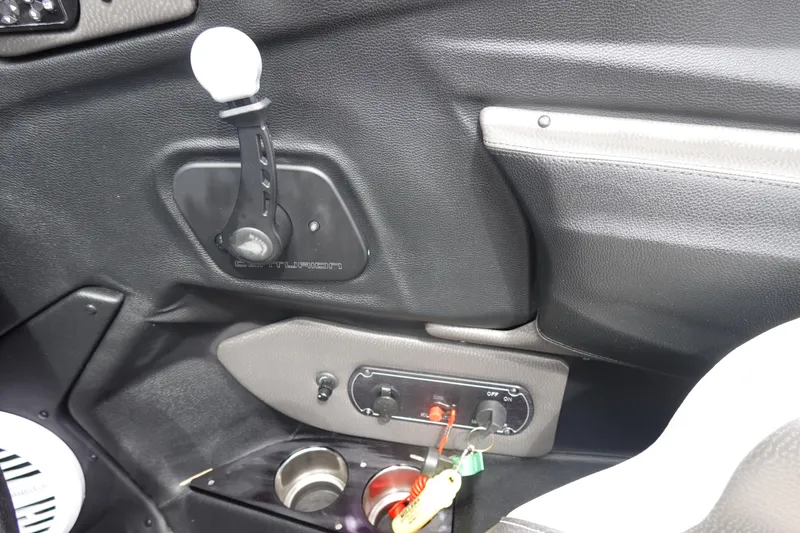 Slide: The Image of Interior of a 2017 Centurion Ri217 boat with control panel and cup holders. - 13