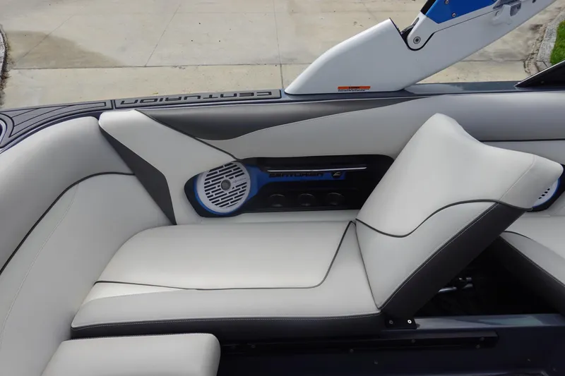 Slide: The Image of 2017 Centurion Ri217 boat interior with sleek white seating and integrated speaker system. - 19