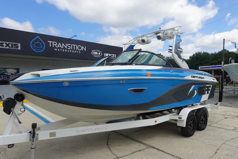 Slide: The Image of 2017 Centurion Ri217 boat in blue on trailer at Transition Watersports dealership. - 2