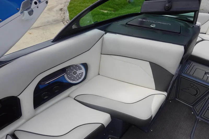 Slide: The Image of 2017 Centurion Ri217 boat interior with white leather seating and built-in speaker. - 20