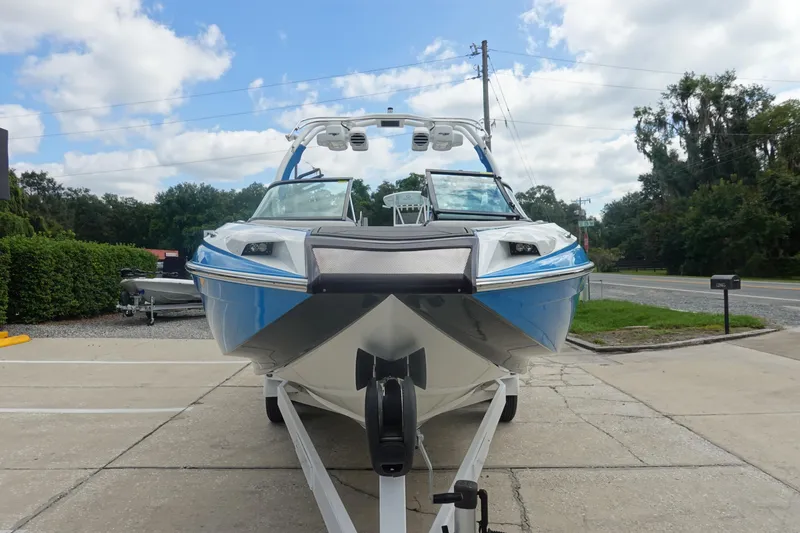 Slide: The Image of 2017 Centurion Ri217 boat on trailer, parked outdoors under a cloudy sky. - 3