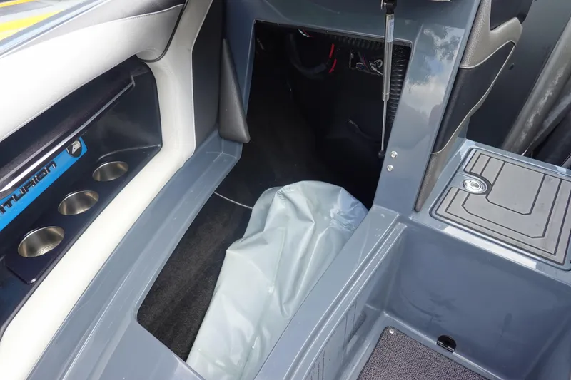 Slide: The Image of Interior of a 2017 Centurion Ri217 boat showing storage and cup holders. - 34