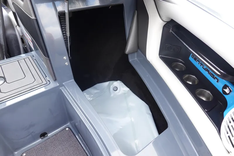 Slide: The Image of 2017 Centurion Ri217 boat interior with storage compartment and cup holders. - 35