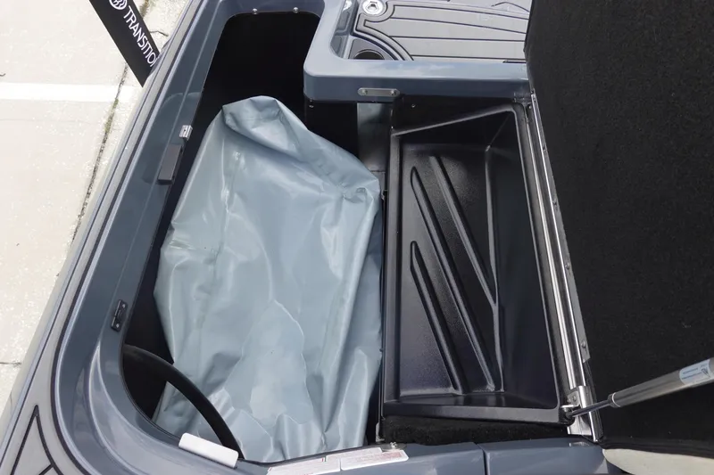 Slide: The Image of Open storage compartment in a 2017 Centurion Ri217 boat, showing interior details. - 36