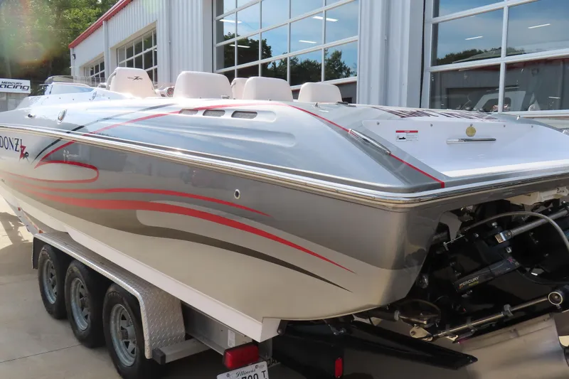 Slide: The Image of 2007 Donzi 35 ZR speedboat with sleek design and red accents, parked on a trailer. - 11