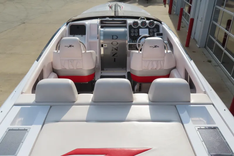 Slide: The Image of 2007 Donzi 35 ZR boat interior with white seating and dashboard controls. - 13
