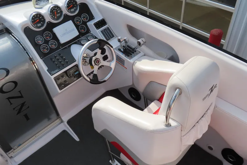 Slide: The Image of 2007 Donzi 35 ZR boat cockpit with steering wheel and control panel. - 16