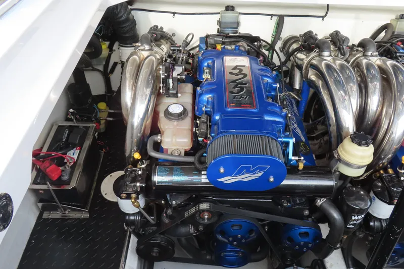 Slide: The Image of 2007 Donzi 35 ZR engine compartment with blue high-performance engine and chrome exhaust headers. - 22