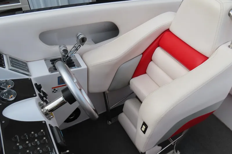 Slide: The Image of 2007 Donzi 35 ZR cockpit with white and red seating, steering wheel, and controls. - 24