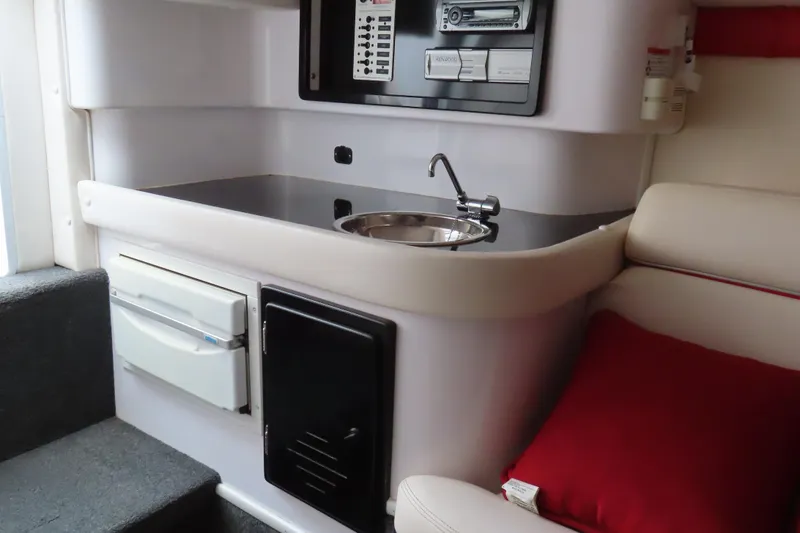 Slide: The Image of 2007 Donzi 35 ZR boat interior with kitchenette, sink, and seating area. - 26