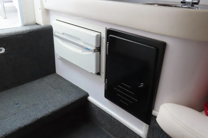 Slide: The Image of 2007 Donzi 35 ZR interior with storage compartments and carpeted steps. - 28