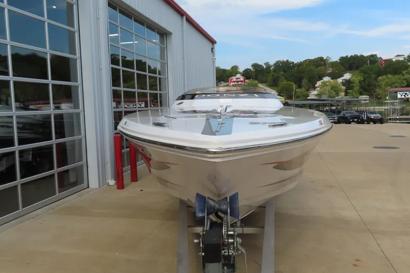 Slide: The Image of 2007 Donzi 35 ZR speedboat on trailer outside a showroom, clear sky background. - 3