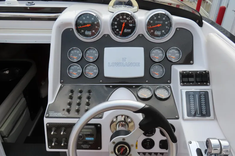 Slide: The Image of Dashboard of a 2007 Donzi 35 ZR boat with gauges and steering wheel. - 31