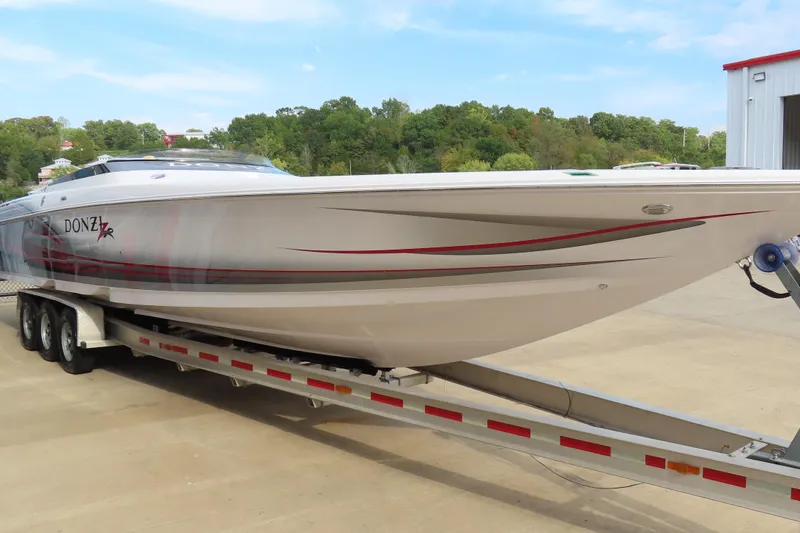 Slide: The Image of 2007 Donzi 35 ZR speedboat on trailer, sleek design with red and gray accents. - 5